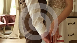 groom and bride holding hands in the room at the wedding