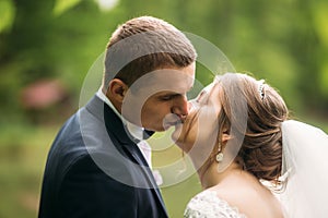 Groom and bride kiss each other in their wedding day