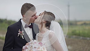 Groom with bride making a kiss. Wedding couple. Happy family. Newlyweds