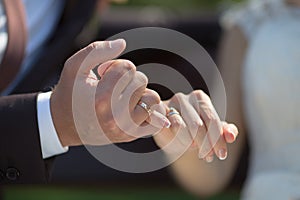 Groom and bride making a pinkie promise