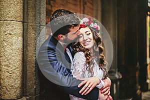 Groom and bride near the columns