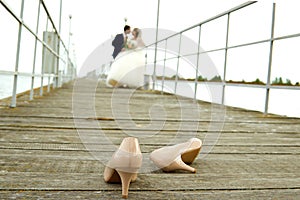 Groom with the bride on the pier in the river port. The bride's