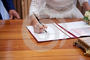 Groom and bride register marriage close up