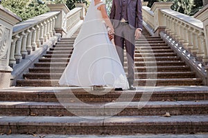 Groom with bride on stairs near the building