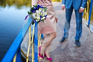 Groom and bride together on wedding day. Newlyweds couple, blurred background, focus on bouquet