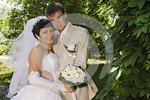 Groom and the bride on walk in park