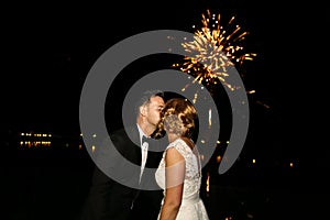 Groom and bride watching the fireworks