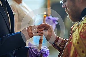 Groom and bride on the wedding engagement ceremony in orthodox church