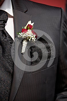 groom with buttonhole rose decoration