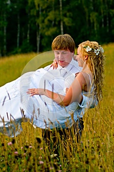 Groom carrying bride