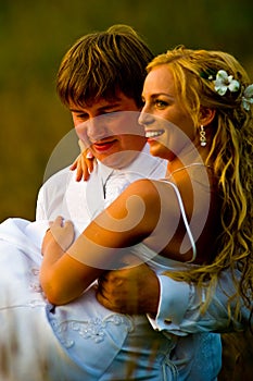 Groom carrying smiling bride