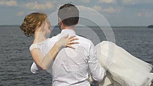 The groom circling bride in his arms