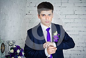 Groom clasping cufflinks