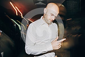 Groom dancing at wedding reception in restaurant. Man in white shirt dancing and having fun at party in night club. Celebration
