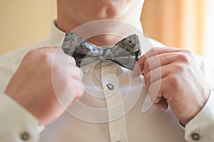 Groom doing a Bowtie adjustment