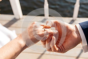 The groom dresses the bride`s engagement ring on the finger. Wedding day