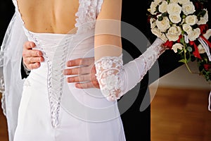 Groom embraces the bride, bride corset
