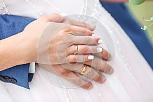 Groom embraces the bride. rings on the hands of newly-married couple