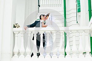 Groom embracing bride and tender touching. Love couple