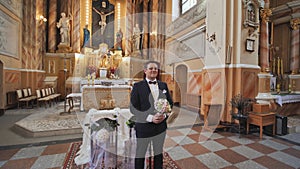 The groom expects his bride during a wedding in the Catholic Church.