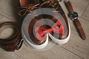 Groom is gathering in the morning.Men& x27;s classic shoes, belt,toilette, perfume, leather strap watch, wedding rings