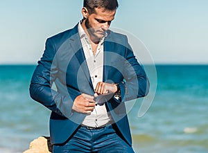 Groom getting ready in the morning for wedding ceremony on the beach