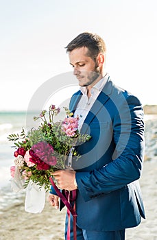 Groom getting ready in the morning for wedding ceremony on the beach