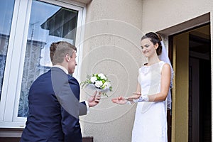 The groom gives the bride flowers