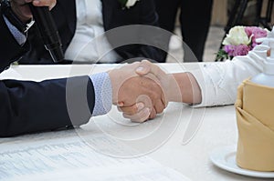 The groom is greeted by the parents of the bride