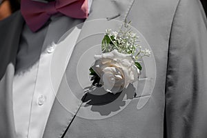 Groom in grey tuxido on Wedding day, closeup details at natural light