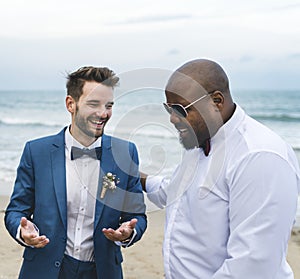 Groom and groomsman at the beach