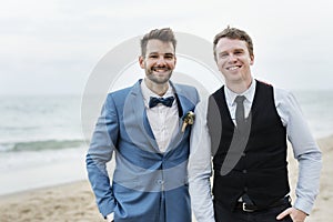 Groom and groomsman at the beach