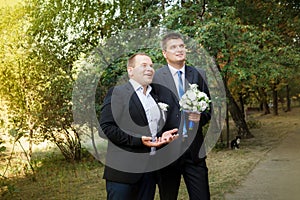 A groom and groomsman came to the bride photo
