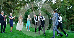 Groom and groomsmen enjoying catching Garter toss 4K 4k