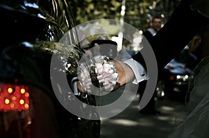 Groom hand opening limousine door