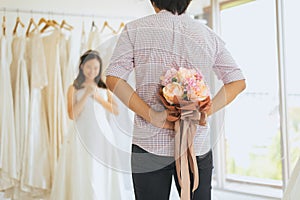 Groom hiding flower behind back in order to surprise bride,Woman positive emotion and face astonished happy and smling