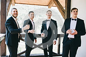 The groom and his friends celebrate the wedding. Men in suits. Murzhsky emotions and friendship.