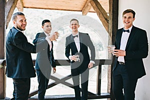 The groom and his friends celebrate the wedding. Men in suits. Murzhsky emotions and friendship.