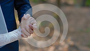 Groom hold hand of his bride