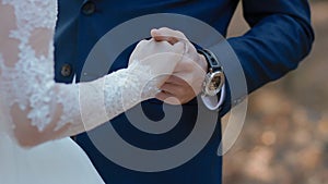 Groom hold hand of his bride