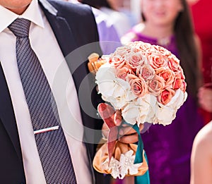 Groom holding a bouquet