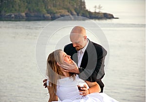 Groom Holding Bride With Red Wine Glass