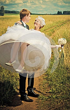 Groom holding his bride