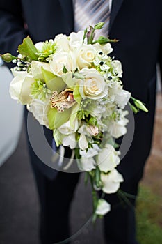 Groom holding a wedding bouquet