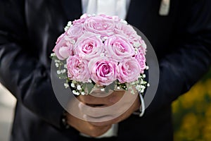 Groom holding a wedding bouquet