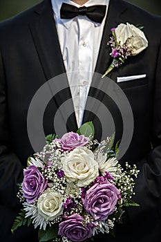 Groom holding wedding bouquet