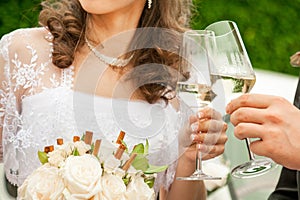 Groom holding wedding champagne glasses