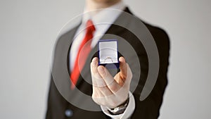 Groom holding wedding ring