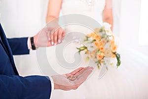 Groom holding wedding rings on the palm, the groom in a blue suit, groom holding wedding rings, groom's hand holding a ring, wedd