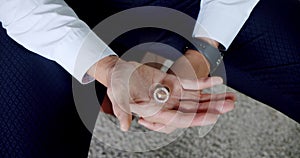 Groom holding wedding rings on the palm, Wedding morning details. Slow motion